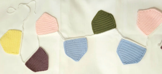 A simple flag garland with yellow, green, pink and blue flags on a white background.