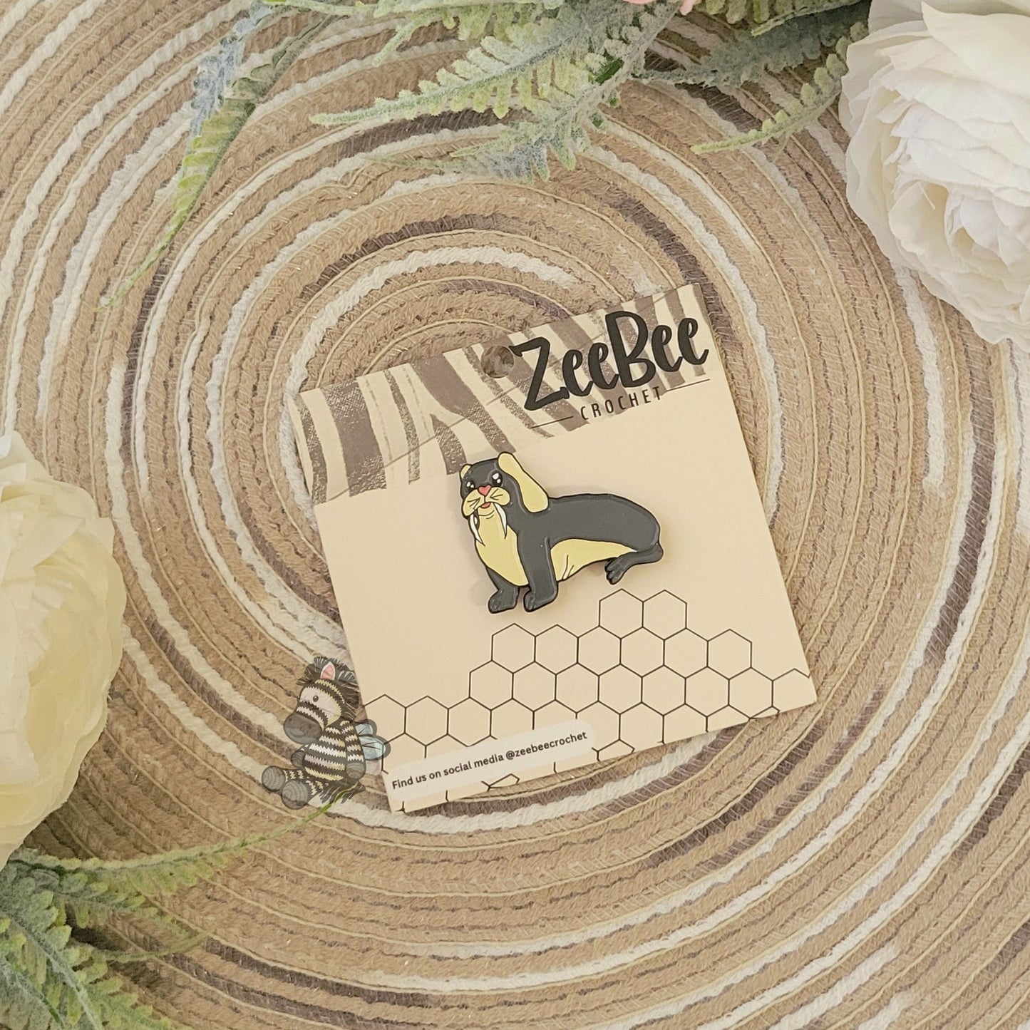 Bunrus, bunny and walrus mashup, pin on a wood grain surface with floral elements