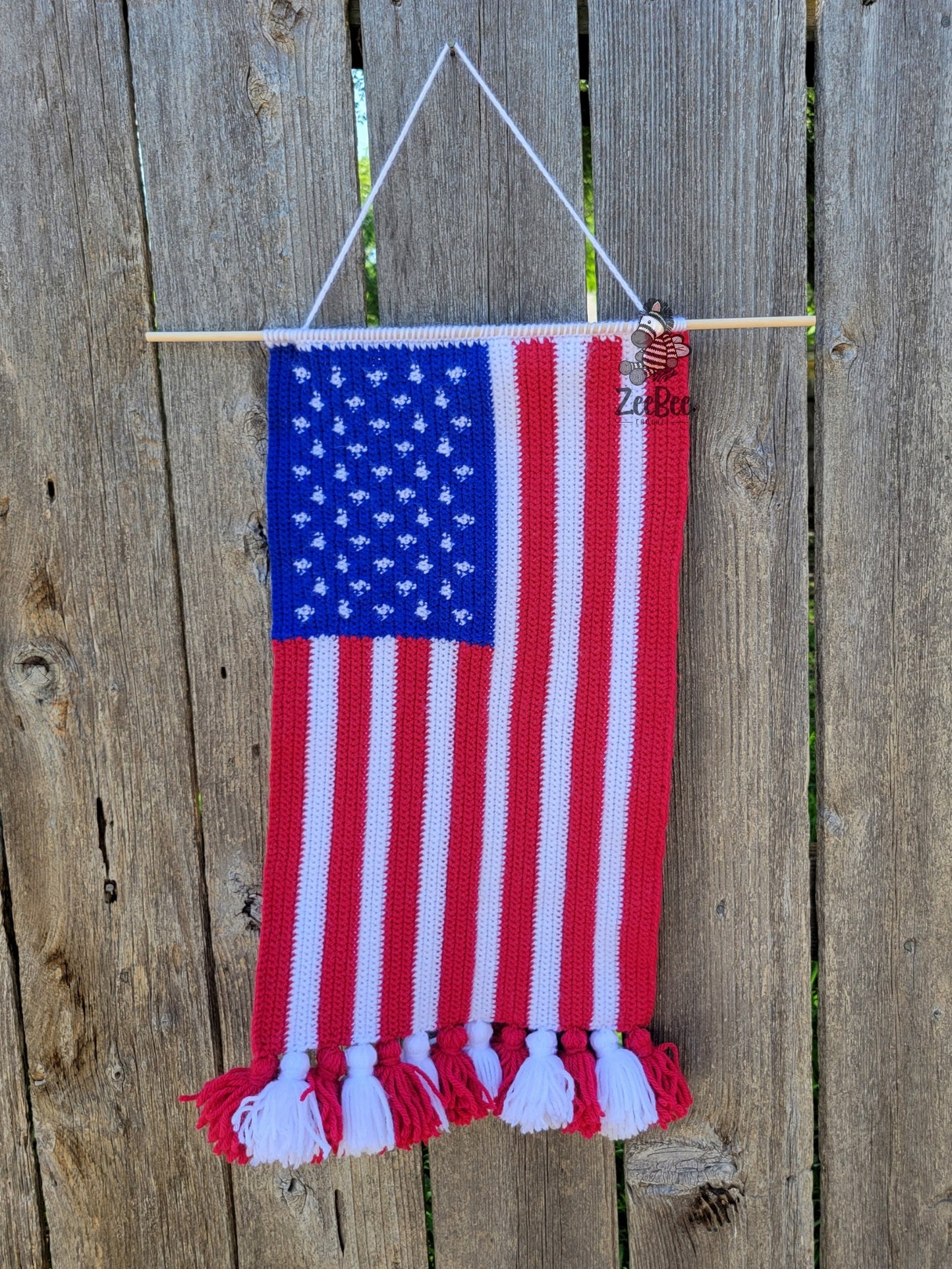 Handmade American flag wall hanging on a wooden fence